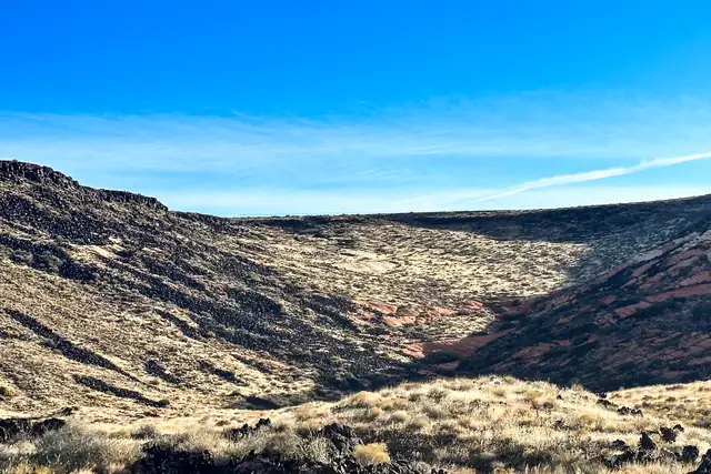 A view down into a lava-floored side canyon with sandstone cliffs on the far side, Snow Canyon State Park.