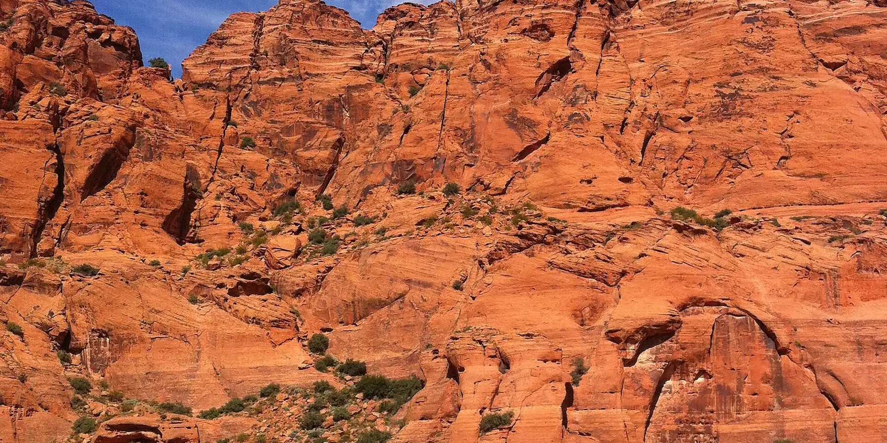 Tall orange-red sandstone rocks under a deep blue sky in Snow Canyon State Park.