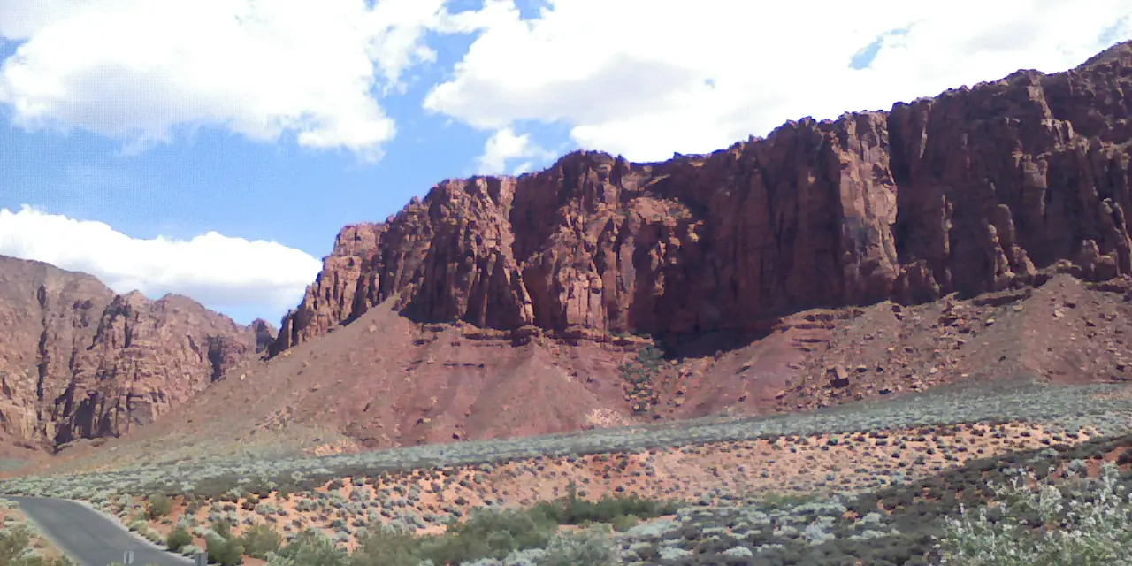Red sandstone cliffs above the road near Kayenta in Ivins, Utah, next to Snow Canyon State Park.